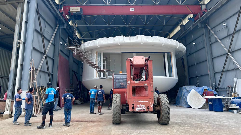 Carefully moving the newly built Eco Pod from the factory using the telehandler