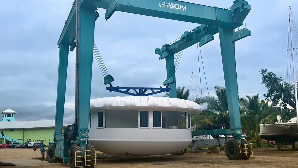 The travel lift transporting the Eco Pod to the barge